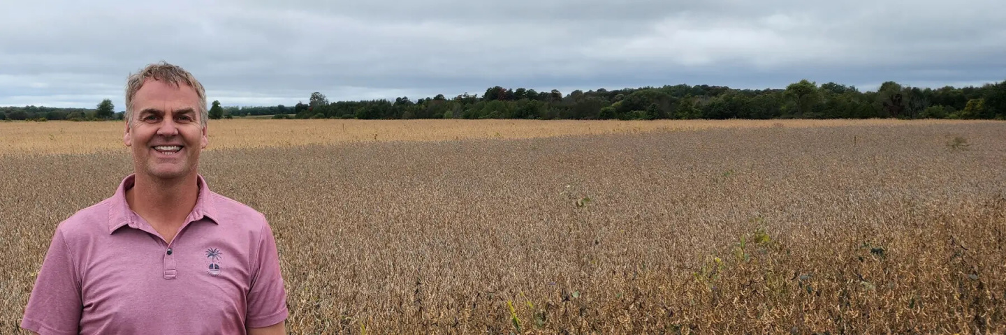Dwight Gerling standing in a field of wheat.